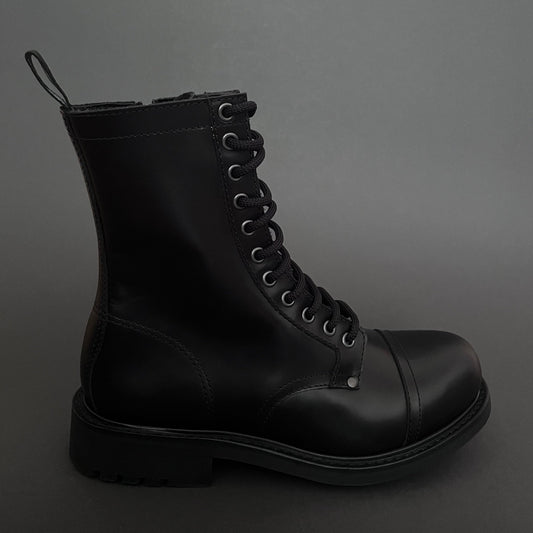 Black leather boot with multiple eyelets on a dark gray background